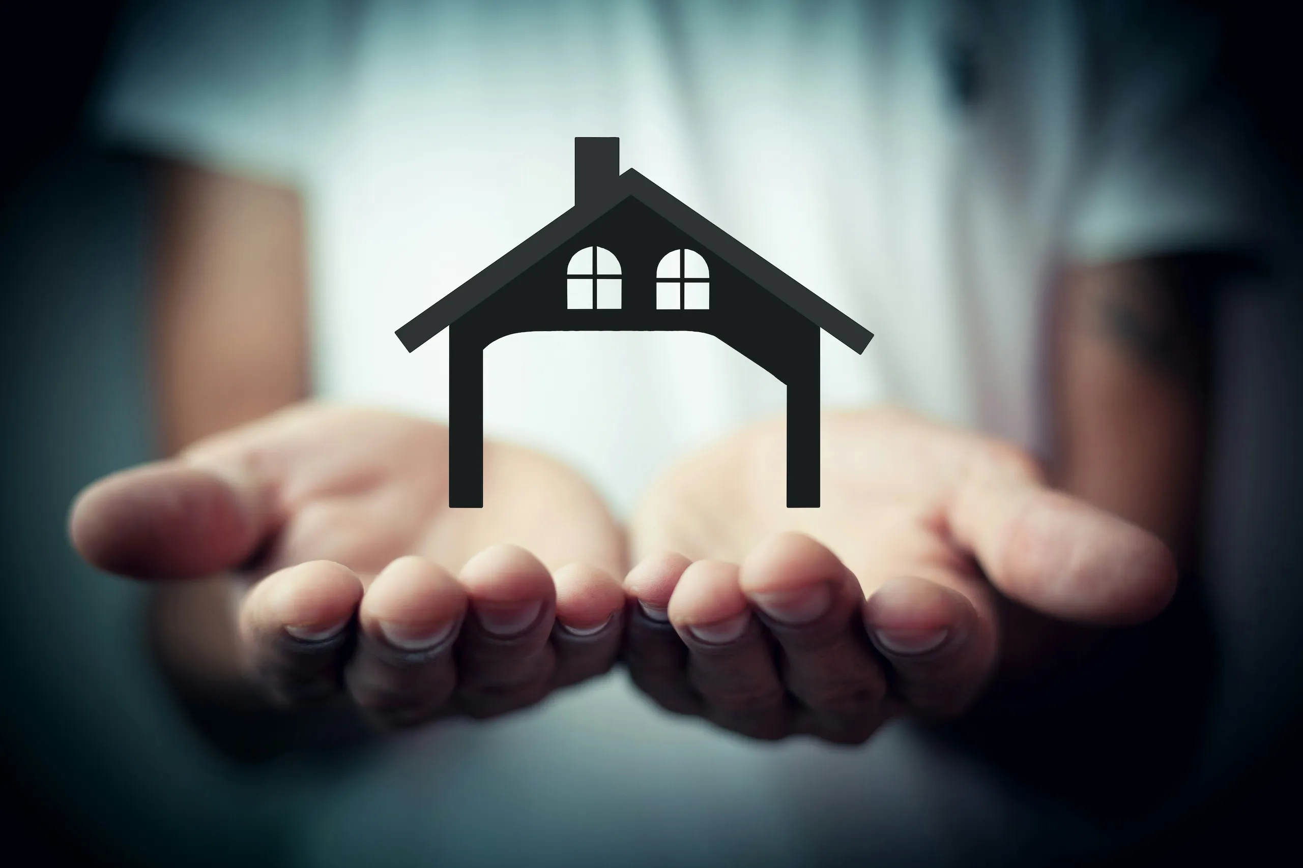 Insurance protection - hands holding a home icon